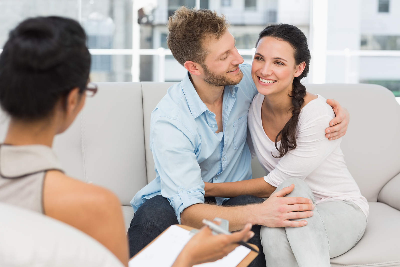 Happy Couple Reconciling At Therapy Session In Therapists Office ...